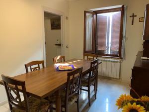 a dining room with a wooden table and chairs at B&B Il Casale in Foligno +8 photos