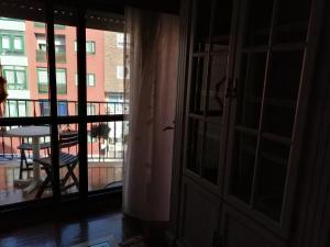 an open door to a balcony with a table at Rotonda da Pedra Alta Apartamento in Cangas de Morrazo