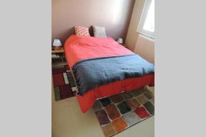 a bedroom with a bed with a red blanket and a window at Maison indépend. 6 personnes à 10 mn de Gérardmer in Granges-sur-Vologne