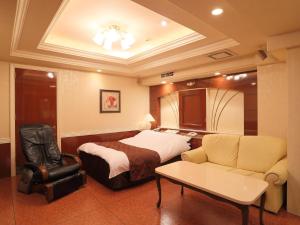 a hotel room with a bed and a couch at Hotel Fine Garden Kuwana in Kawagoe +16 photos
