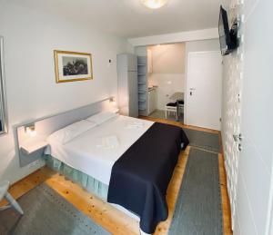 a bedroom with a large bed in a room at Komiza Provita Guesthouse in Komiža