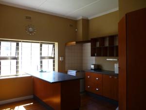 a kitchen with a counter and a window in it at Royal Guest House in East London