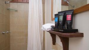a shelf with books on it in a bathroom at Milkwood Lodge in Cooktown +14 photos