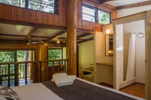 a bedroom with a large bed in a house at Milkwood Lodge in Cooktown