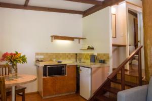 a small kitchen with a sink and a counter at Milkwood Lodge in Cooktown