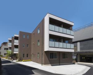 an apartment building on a city street at Eisei Stay in Tokyo