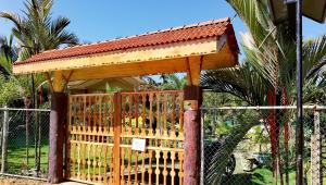 a wooden gate with a wooden roof on a fence at Sea View Resort in Kallady