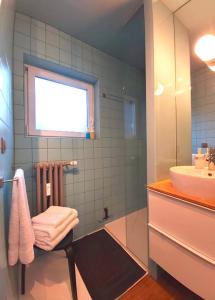 a bathroom with a sink and a toilet and a shower at Bright and stylish apartment next to the sea! in Ostend
