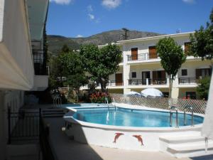 a swimming pool in front of a building at Oasis in Parga