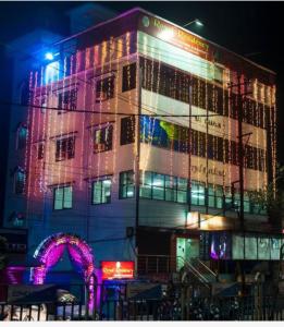 a building with christmas lights on the side of it at Hotel Royal Residency in Siliguri