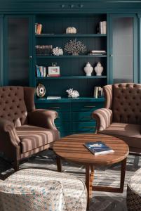 a living room with two couches and a coffee table at Vivid Blue Serenity Resort in Sveti Stefan