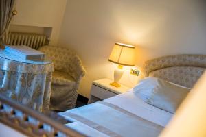 Postel nebo postele na pokoji v ubytování Hotel 4 Stagioni Sensus Spa