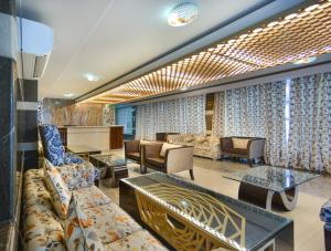 a living room with couches and a table at The Montreal Srinagar A Unit Of Montreal Group in Srinagar