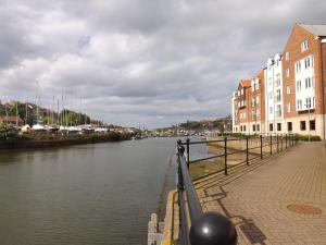 a view of a river with buildings and houses at Harbour View is the Perfect Staycation in Whitby