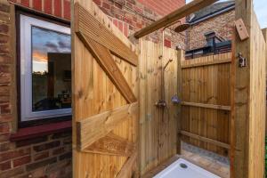 a bathroom with a wooden fence and a wooden door at Palm Bay Beach House in Margate +23 photos