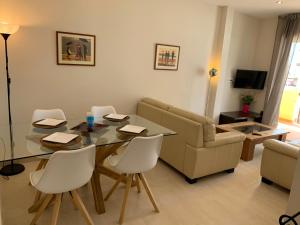 a living room with a table and chairs and a couch at Apartment on the beach,fuengirola in Fuengirola