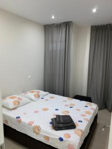 a bedroom with a large bed with a purse on it at Apartment on the beach,fuengirola in Fuengirola