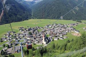 a small village in a valley with a ski lift at Mascherhof in Obertilliach