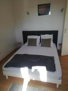 a bedroom with a white bed with lights on it at Ancienne caserne du château in Azille