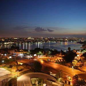a city at night with a river and a city at Daru Sultan Hotels Galata in Istanbul