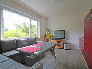a living room with a table and a couch at Möwennest am Ihlsee in Bad Segeberg