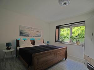 a bedroom with a large bed and a window at Möwennest am Ihlsee in Bad Segeberg