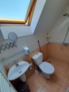 a bathroom with a sink and a toilet and a window at Guest House Diel in Veliko Tŭrnovo