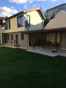 a house with a patio and a grass yard at Maremi in Timişoara