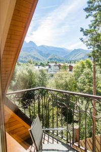 a balcony with a chair and a view of mountains at Wilcznik 10 in Zakopane