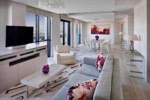 a living room with a couch and a tv at Hyatt Regency Creek Heights Residences in Dubai