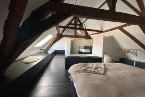 a bedroom with a large bed in a attic at GLORIA LOFT GENT in Ghent