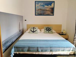 a bedroom with a bed and a picture on the wall at Guesthouse ROCK & ROLL in Rovinj