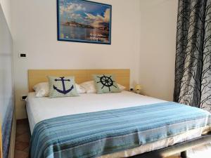 a bedroom with a large bed with a blue blanket at Guesthouse ROCK & ROLL in Rovinj