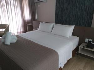 Een bed of bedden in een kamer bij Rainha do Mar