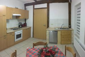 a kitchen with a table with a christmas arrangement on it at Ferienhaus Ackerbürgerhof in der Welterbestadt Quedlinburg in Gernrode - Harz