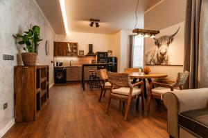 a kitchen and living room with a table and chairs at STING Boutique Apartments in Ostrava