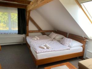 a bedroom with a bed with two towels on it at Čtyři pokoje in Tachov