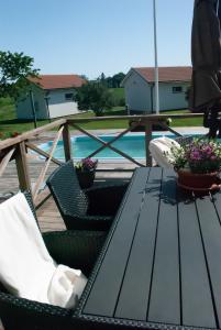 a wooden table and chairs on a patio at Nordanå Gård in Strö