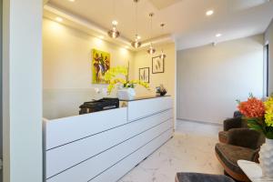 a waiting room at a clinic with flowers at The Alima Suites in Accra