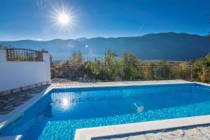 a swimming pool with a view of the mountains at Villa Stipanovi Dvori in Vodenjak