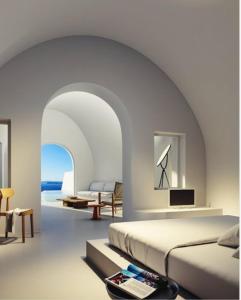 a bedroom with a bed and a living room at Aspaki by Art Maisons in Oia +37 photos