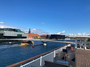 a bridge over a river with a boat in the water at Hotel CPH Living in Copenhagen