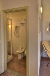 a bathroom with a toilet, sink and shower at Albergo San Lorenzo in Poppi