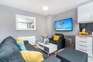 uma sala de estar com um sofá e uma televisão em Elegant Flat Near Stonehenge, Amesbury Town Centre Smart TVs Netflix FREE PARKING em Amesbury