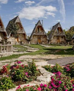 een groep huizen met bloemen voor hen bij Eco Village Nevidio in Pošćenje