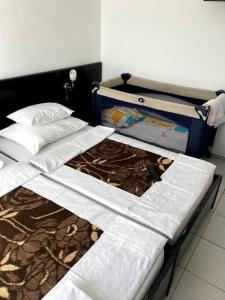 two beds sitting next to each other in a room at Guest house Dragović in Sveti Stefan