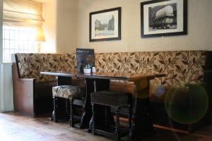 a bar with a table and chairs in a restaurant at Duke Of Wellington in Matlock