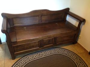 a wooden bed in the corner of a room at Family House Nichka in Pochayiv