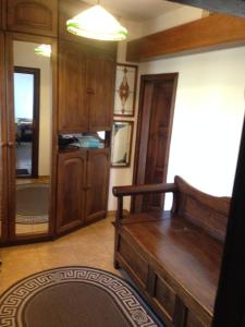 a living room with a couch and wooden cabinets at Family House Nichka in Pochayiv