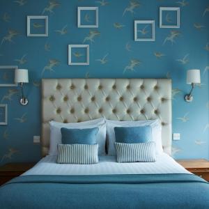 um quarto com uma cama com paredes azuis em The Old Ship Hotel em Brighton & Hove